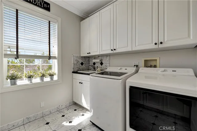 an aerial view of a city with lots of residential buildings and mountain view in back