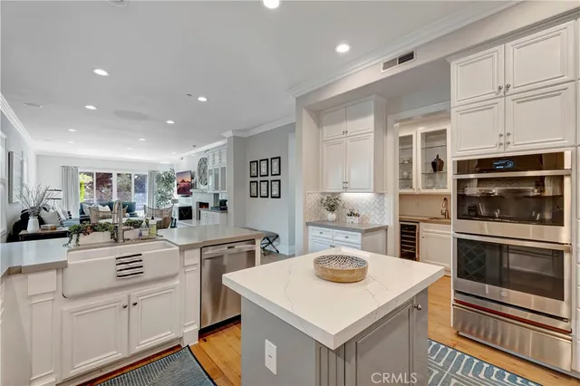 a kitchen with a sink a stove cabinets and counter space
