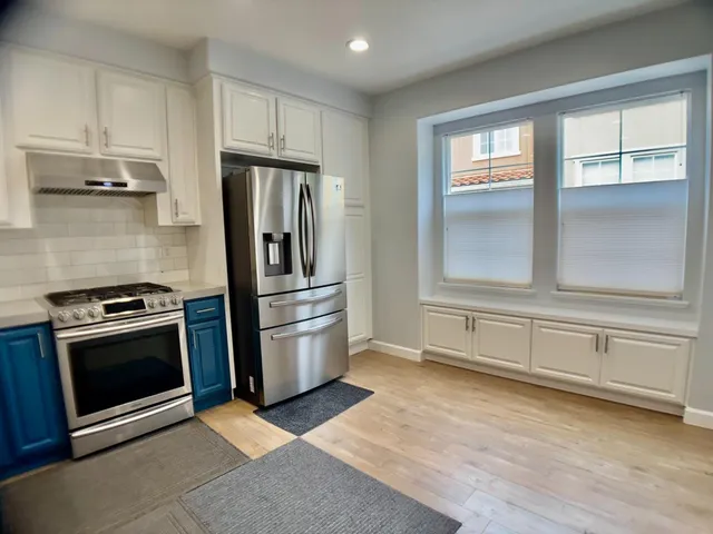 a stove top oven sitting inside of a kitchen
