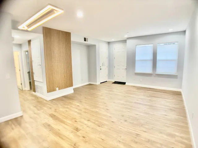 a kitchen with granite countertop white cabinets and stainless steel appliances