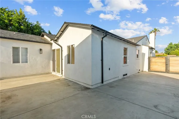 a backyard of a house with garage and outdoor seating