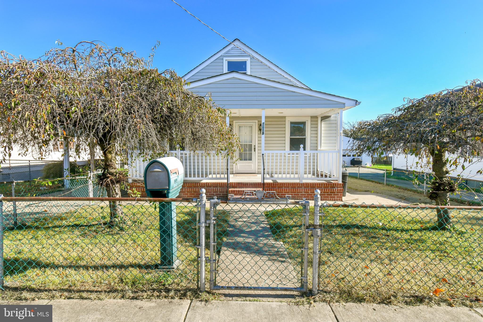 7618 Spruce Road Baltimore, MD 21222 - Photo 2 of 42 a front view of a house with garden