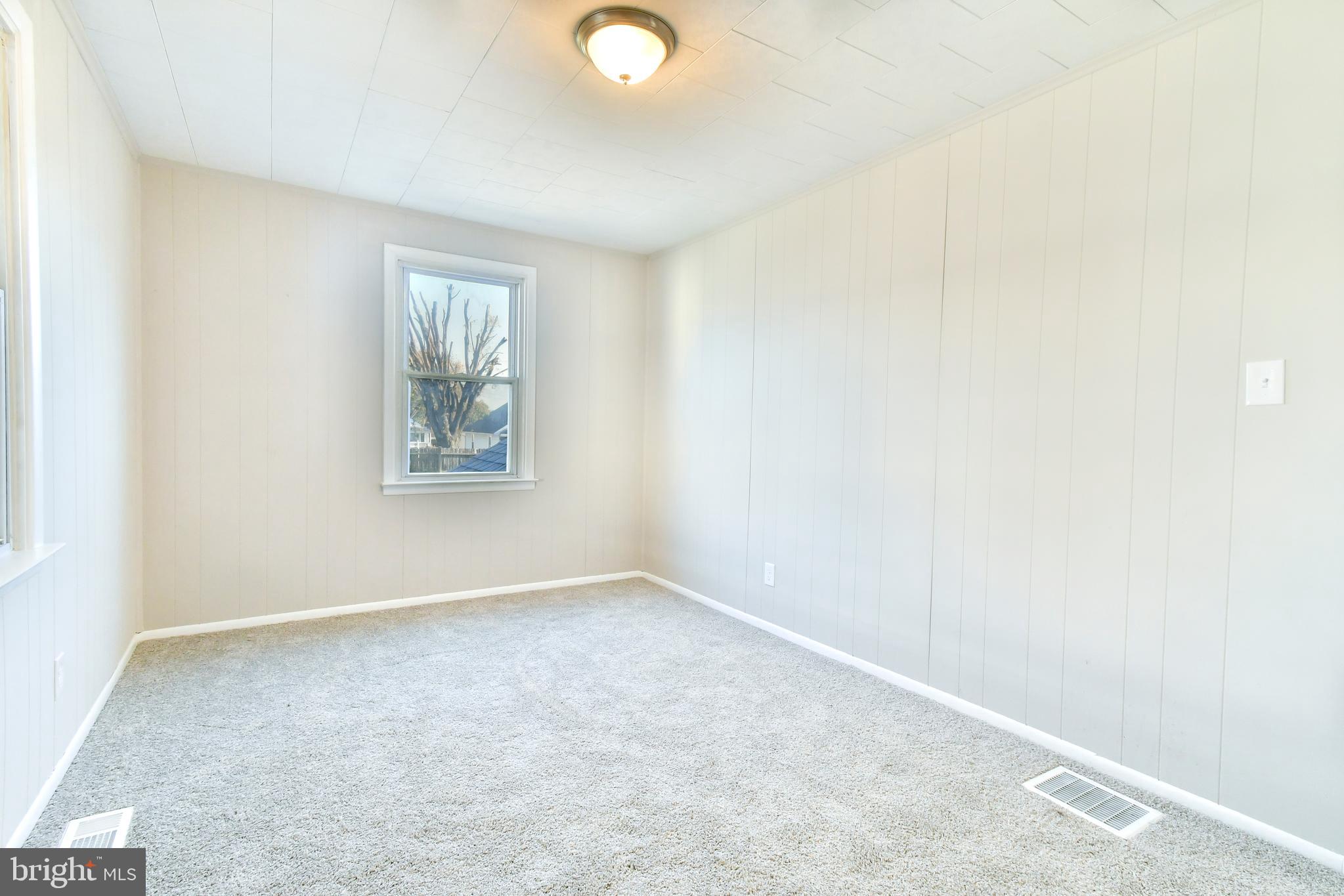 7618 Spruce Road Baltimore, MD 21222 - Photo 14 of 42 an empty room with windows