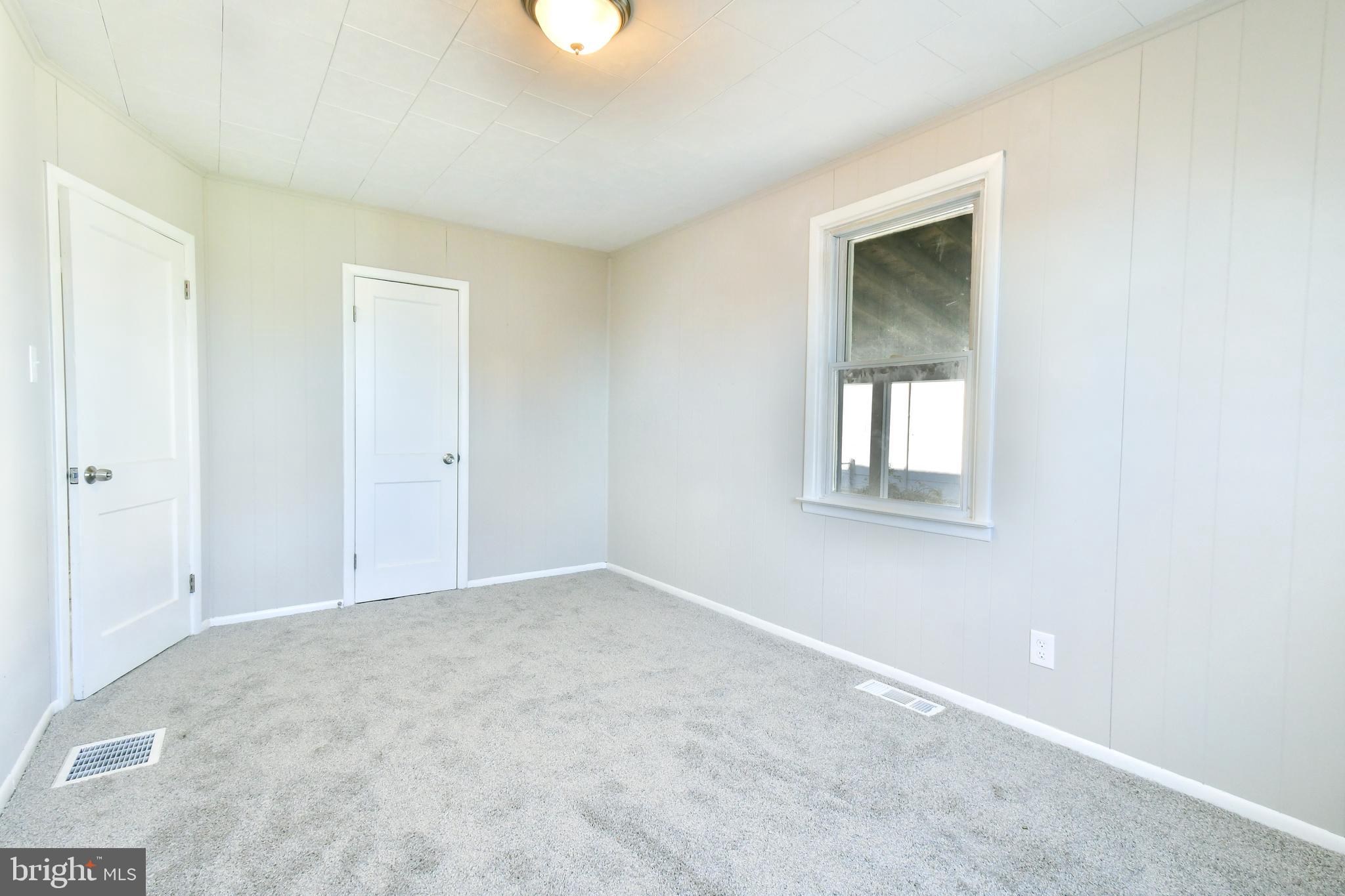 7618 Spruce Road Baltimore, MD 21222 - Photo 16 of 42 an empty room with windows and closet