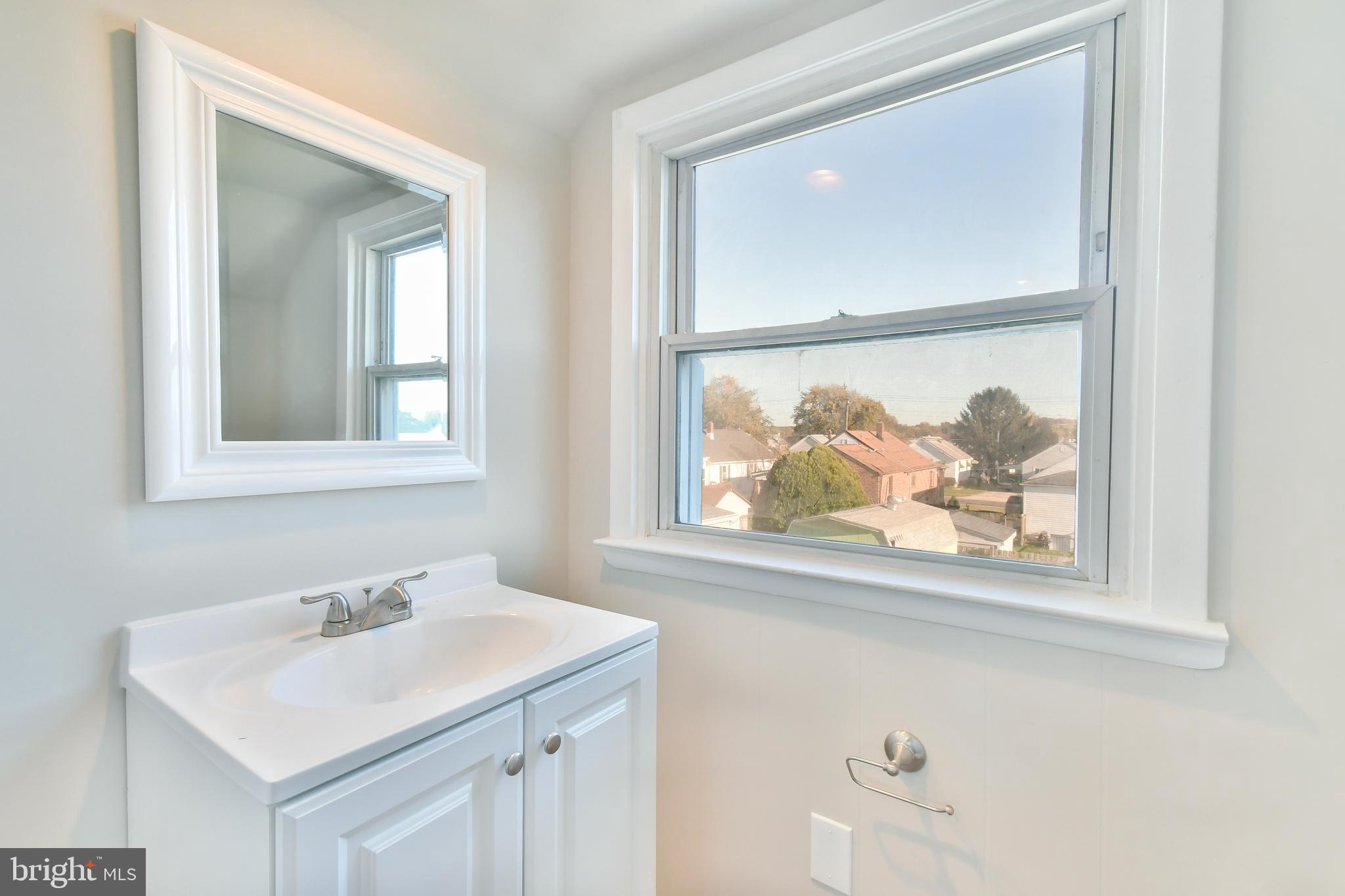 7618 Spruce Road Baltimore, MD 21222 - Photo 28 of 42 a bathroom with a sink and a mirror