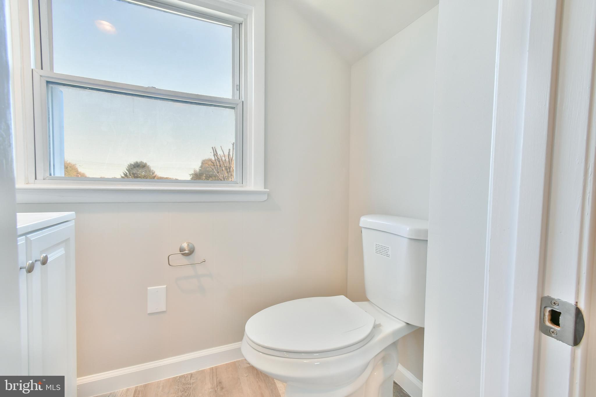 7618 Spruce Road Baltimore, MD 21222 - Photo 29 of 42 a white toilet sitting next to a bathroom sink