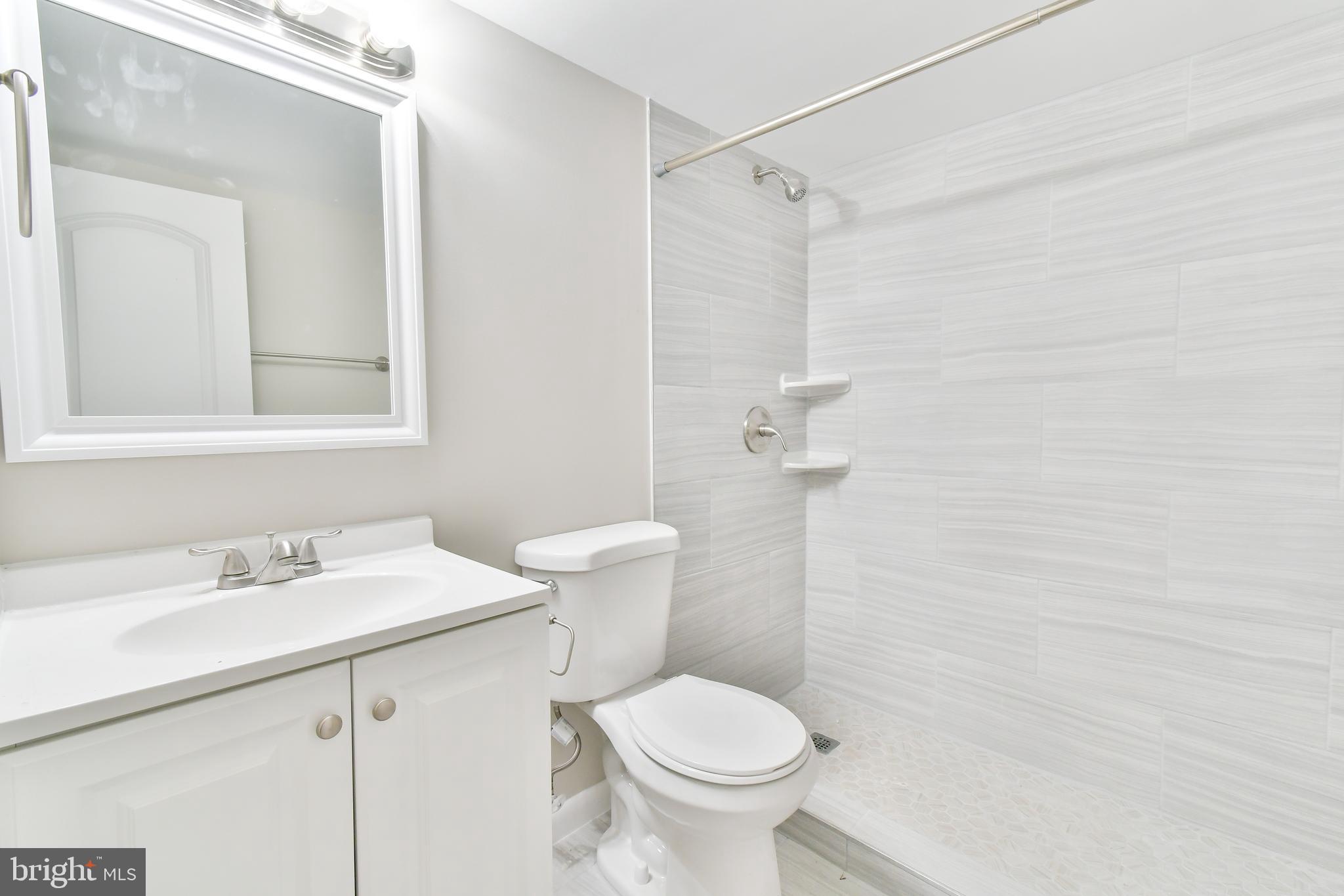 7618 Spruce Road Baltimore, MD 21222 - Photo 34 of 42 a bathroom with a sink toilet and vanity