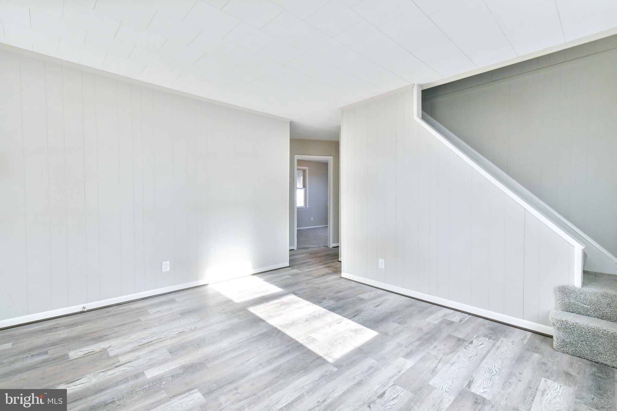 7618 Spruce Road Baltimore, MD 21222 - Photo 6 of 42 a view of an empty room with wooden floor and entryway