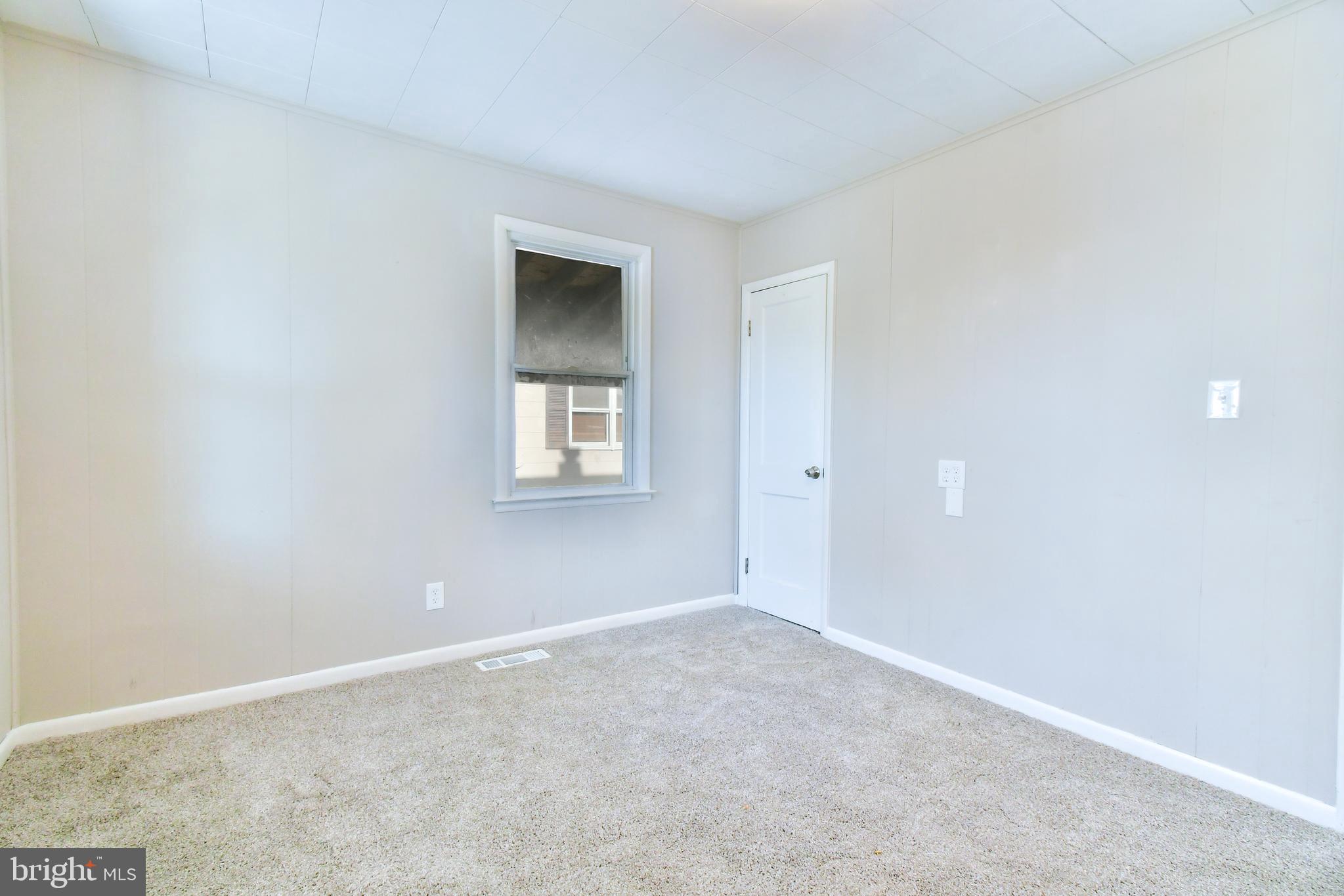 7618 Spruce Road Baltimore, MD 21222 - Photo 10 of 42 an empty room with windows