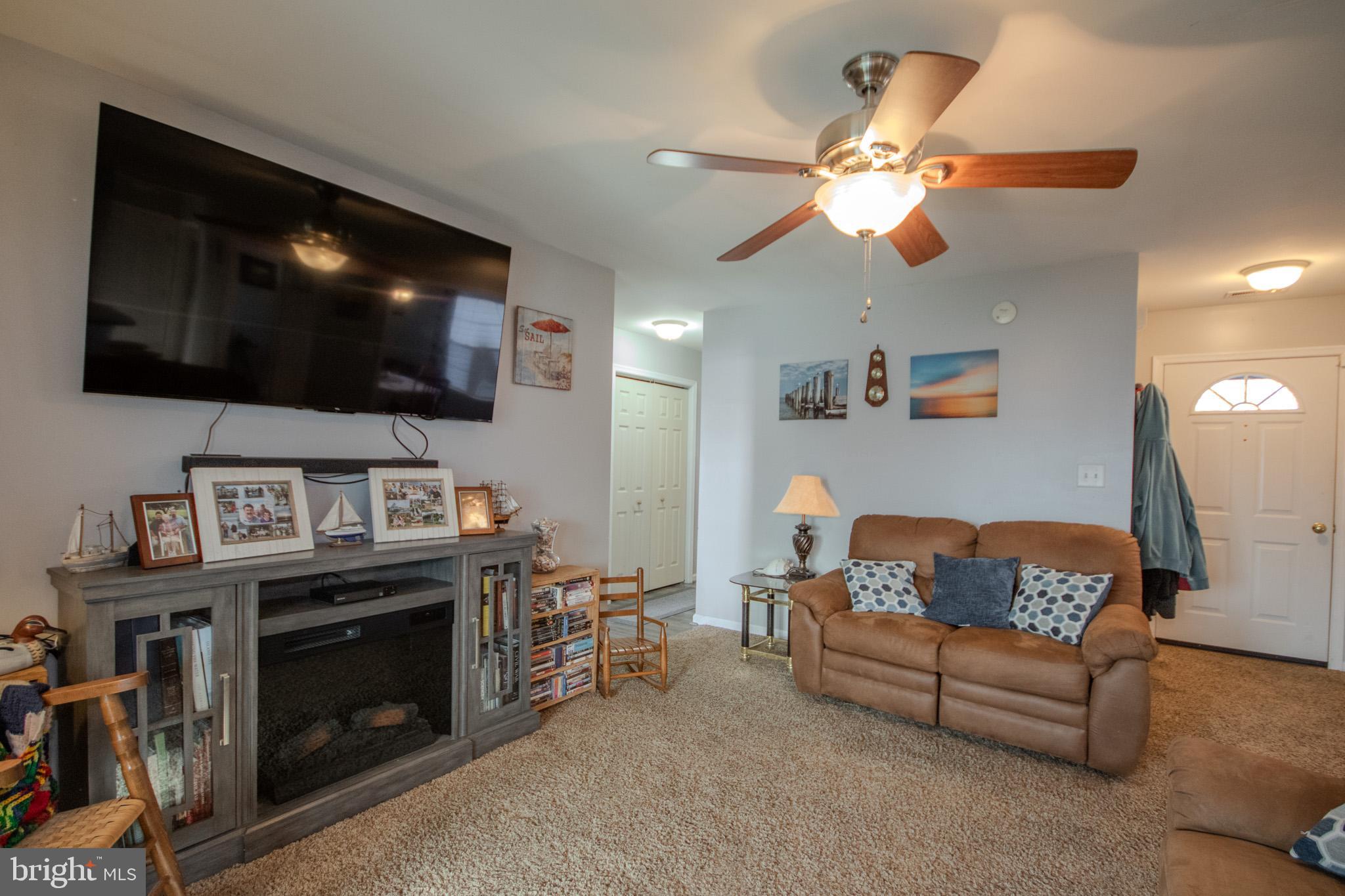 30071 Deanwood Road Princess Anne, MD 21853 - Photo 12 of 37 a living room with furniture and a flat screen tv