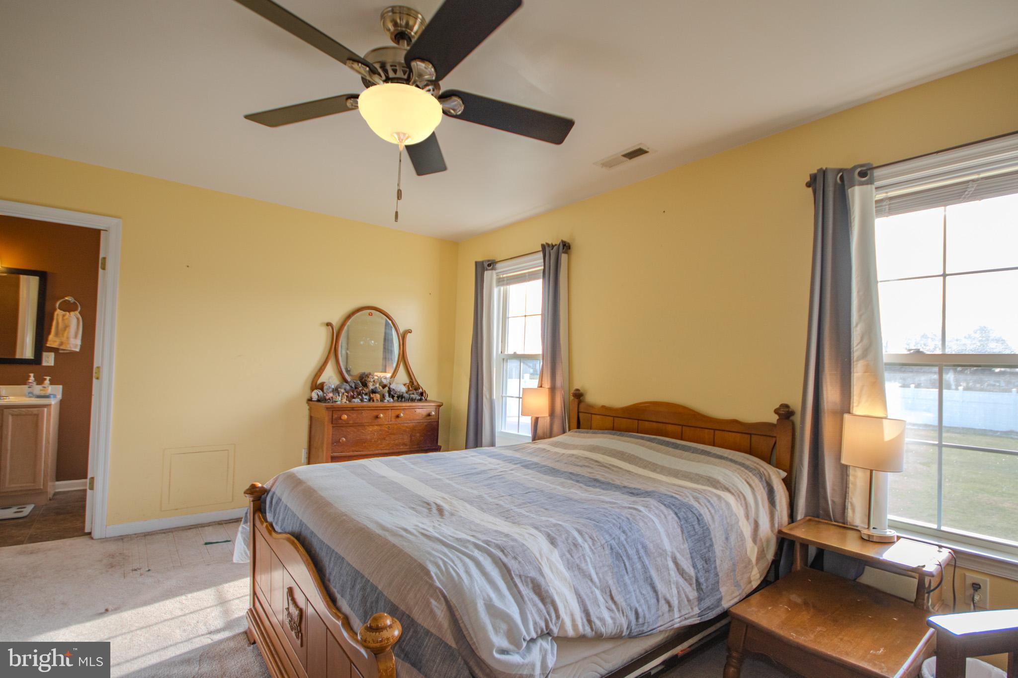 30071 Deanwood Road Princess Anne, MD 21853 - Photo 14 of 37 a bedroom with a bed and a chandelier