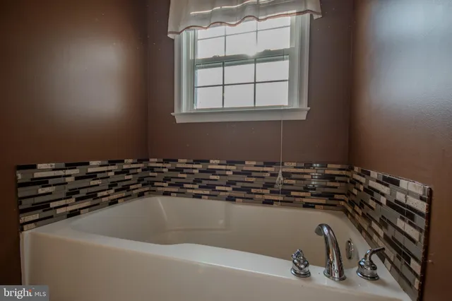 a close view of a sink a faucet and a window