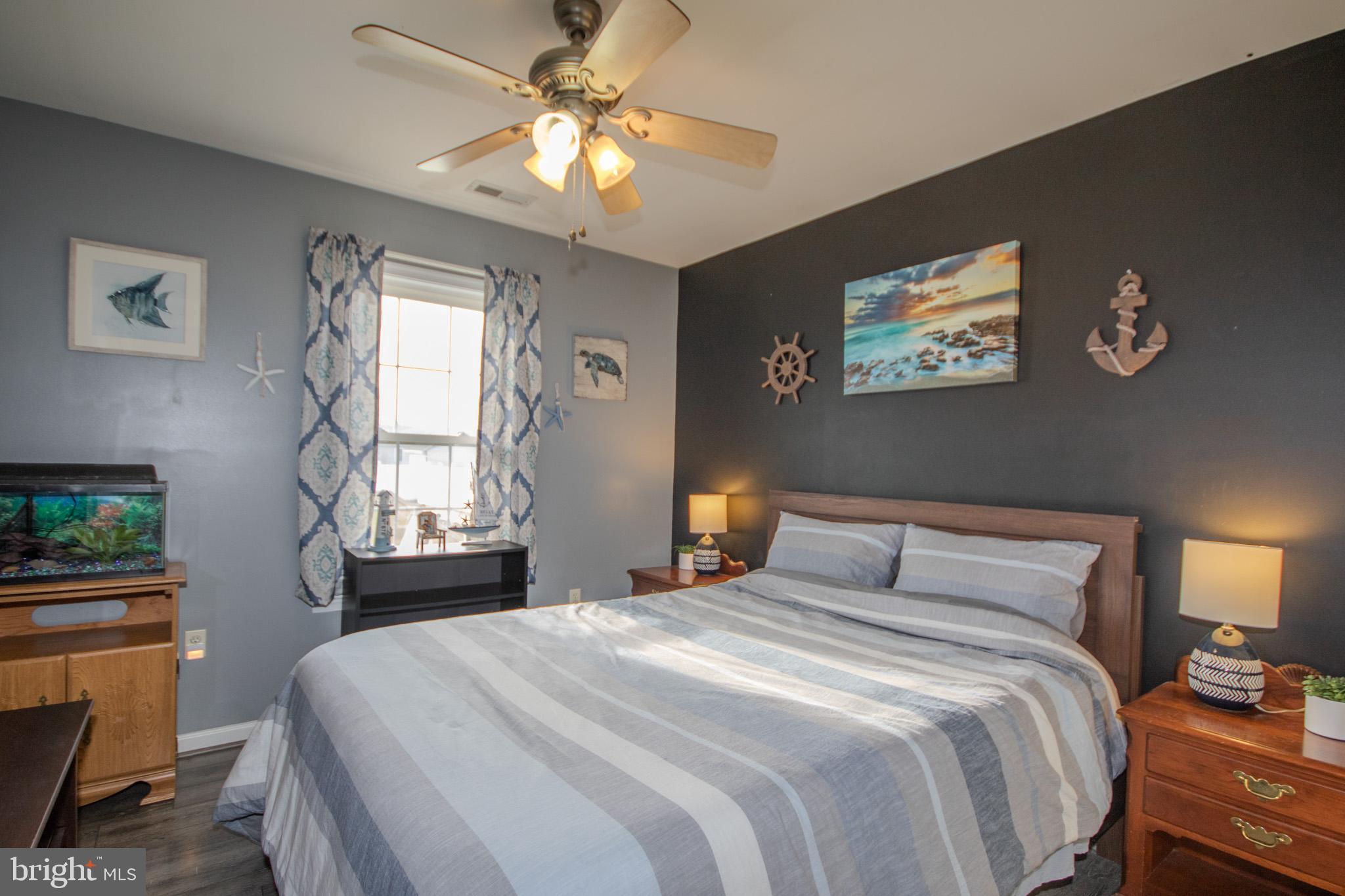 30071 Deanwood Road Princess Anne, MD 21853 - Photo 19 of 37 a bedroom with a bed and a chandelier