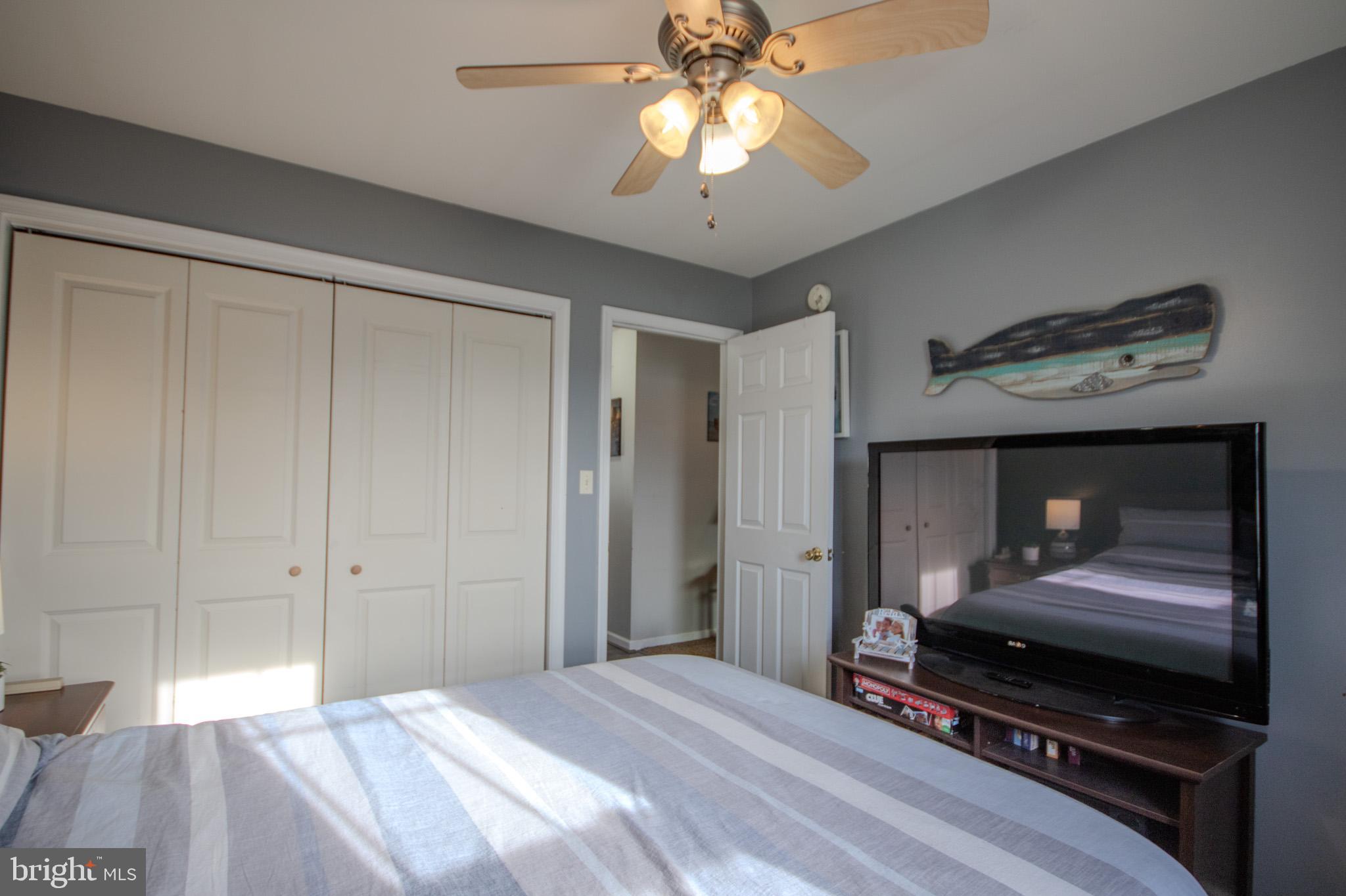 30071 Deanwood Road Princess Anne, MD 21853 - Photo 21 of 37 a bedroom with a bed and a chandelier