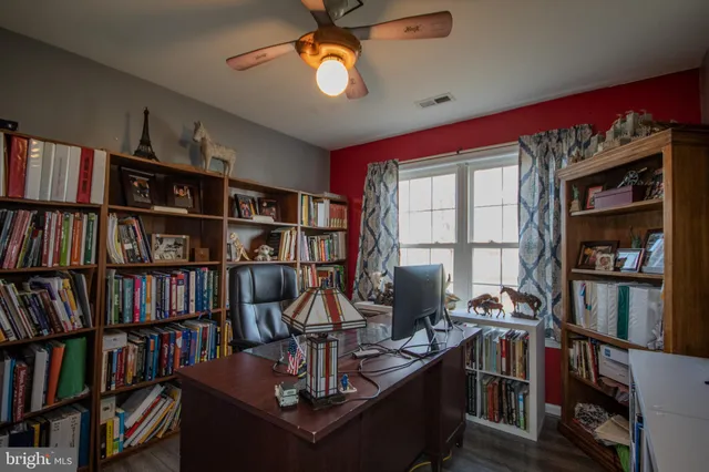 a view of a workspace with bookshelf