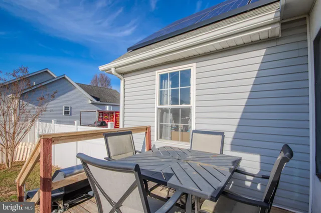 a view of a house with backyard and furniture