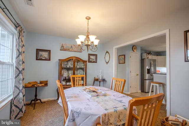 a view of a dining room with furniture and chandelier