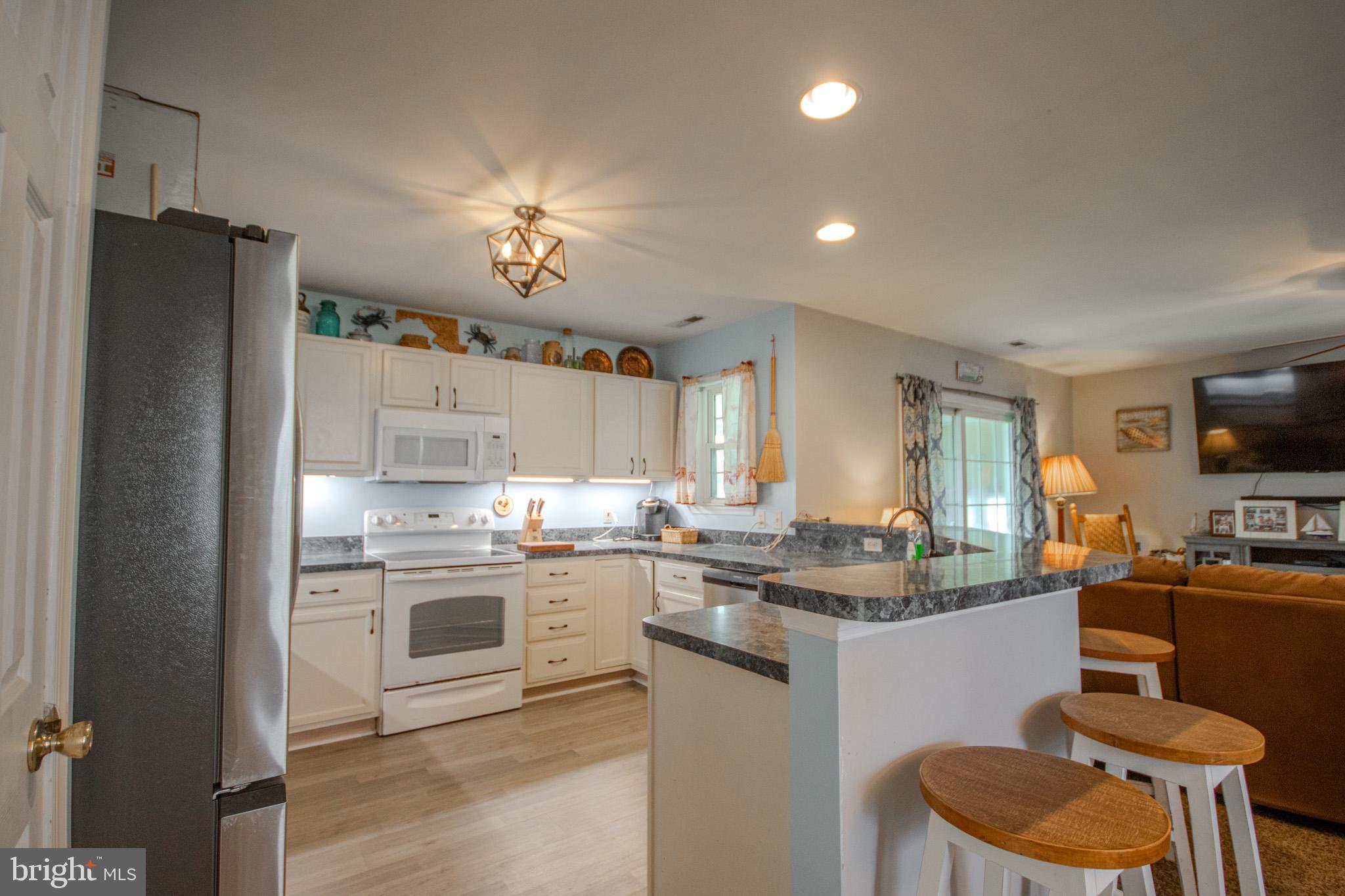 30071 Deanwood Road Princess Anne, MD 21853 - Photo 9 of 37 a kitchen with kitchen island a sink stove and refrigerator