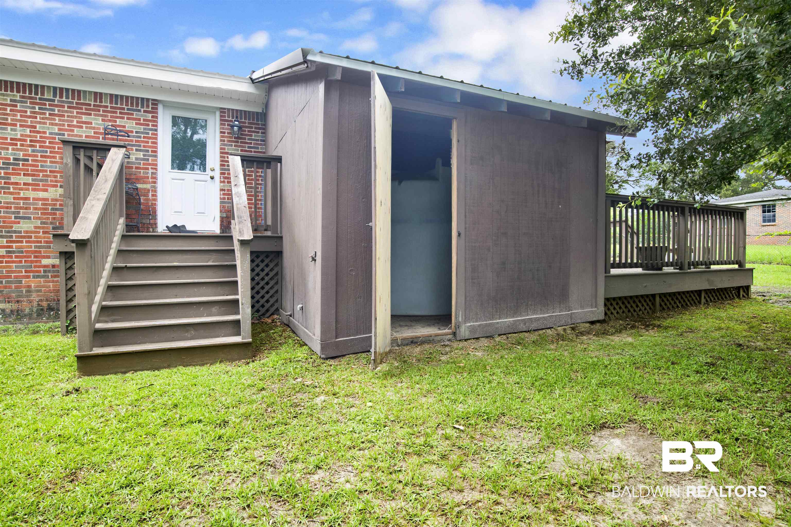 17714 Horseneck Road Bay Minette, AL 36507 - Photo 26 of 36 Brick exterior with a multi-level wooden deck featuring lattice skirting