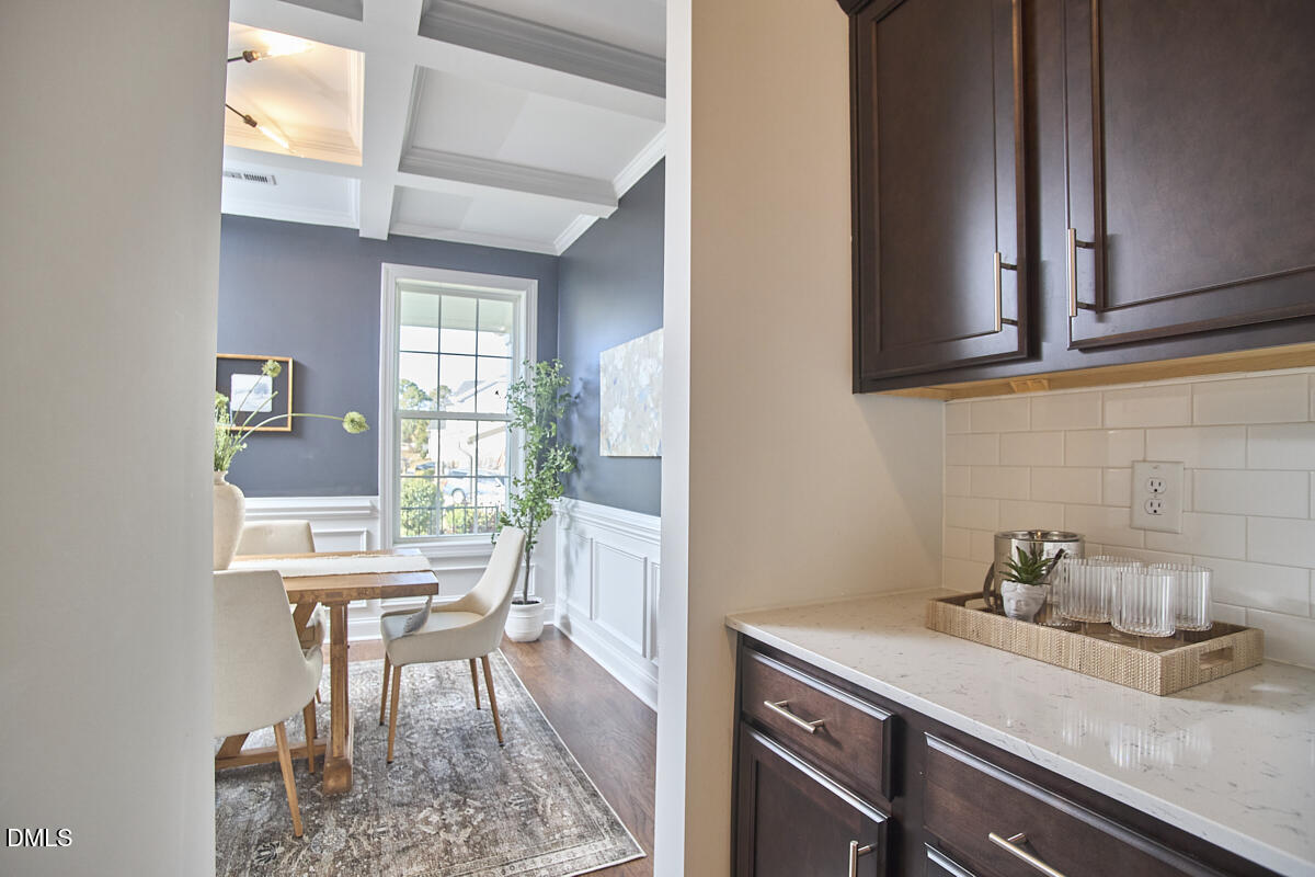 8600 Rowan Oak Court Wake Forest, NC 27587 - Photo 12 of 42 a view of a kitchen area with furniture and wooden floor