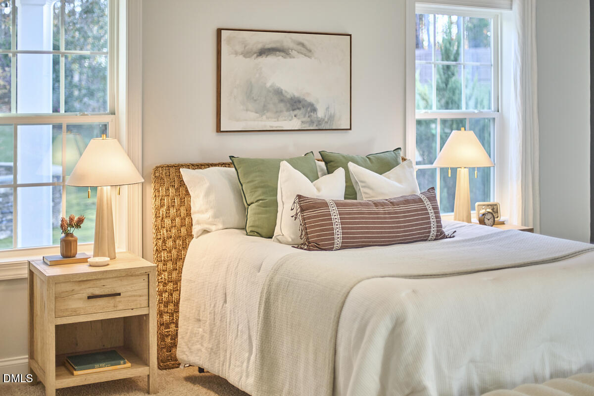 8600 Rowan Oak Court Wake Forest, NC 27587 - Photo 18 of 42 a bedroom with a bed and a painting on the wall