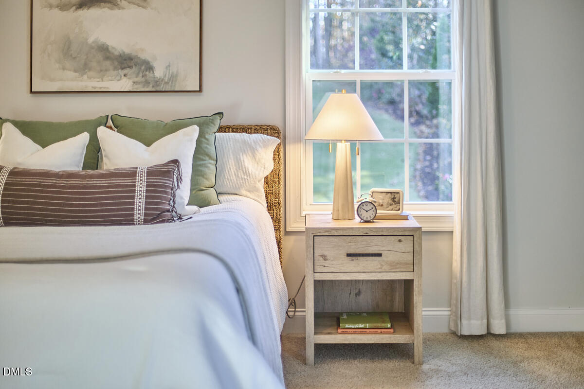 8600 Rowan Oak Court Wake Forest, NC 27587 - Photo 19 of 42 a bed room with a bed and a table