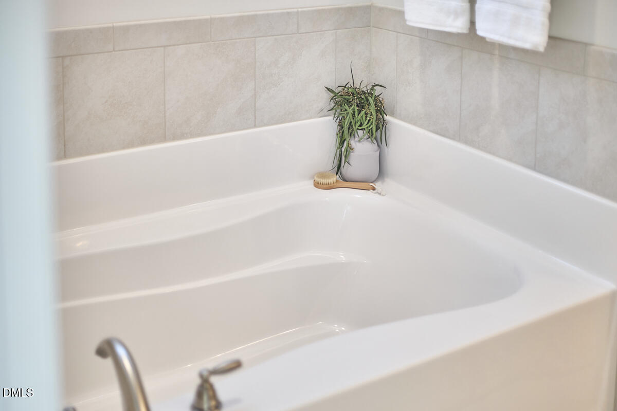 8600 Rowan Oak Court Wake Forest, NC 27587 - Photo 24 of 42 a white bath tub with a shower