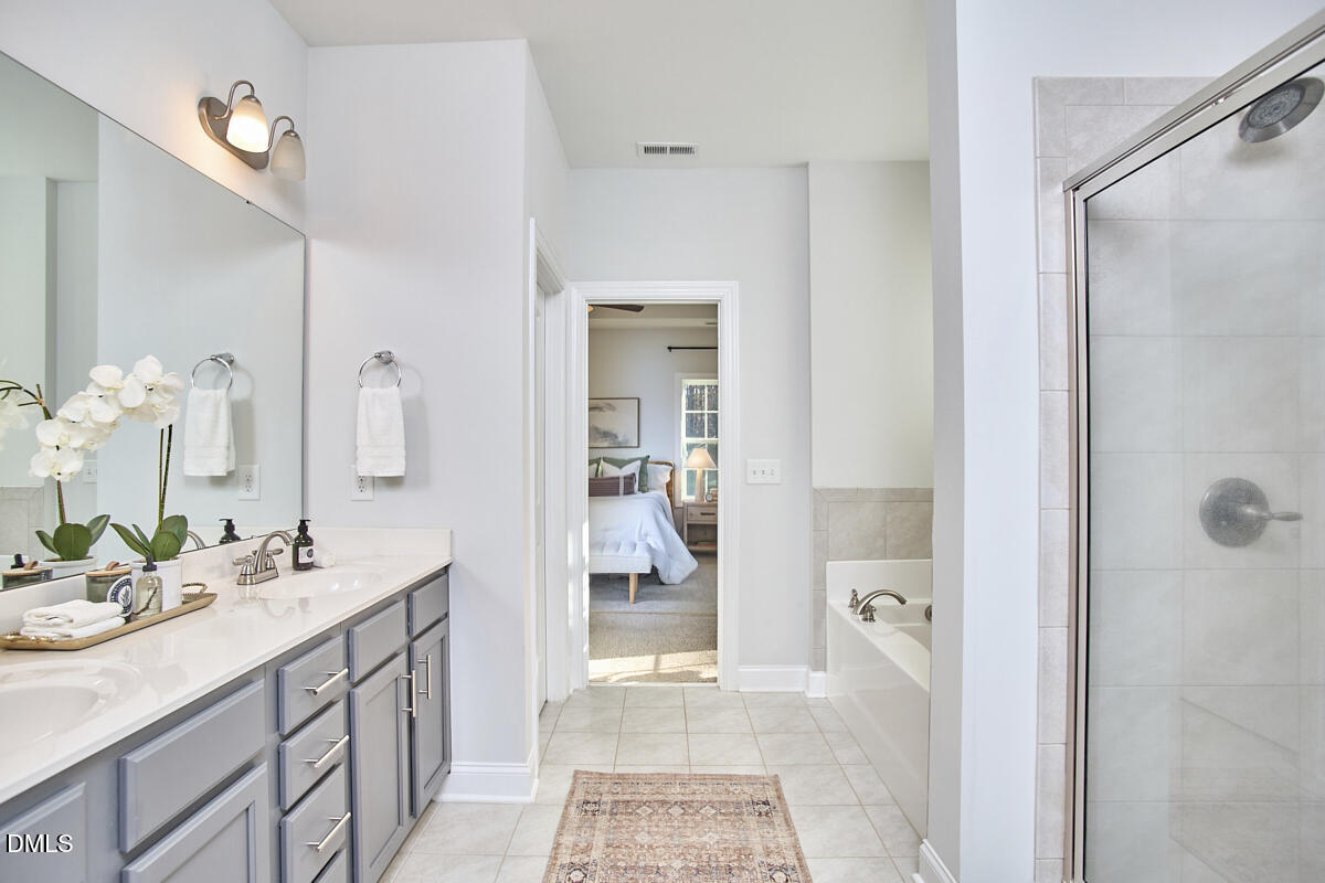 8600 Rowan Oak Court Wake Forest, NC 27587 - Photo 26 of 42 a bathroom with a sink a vanity and a mirror