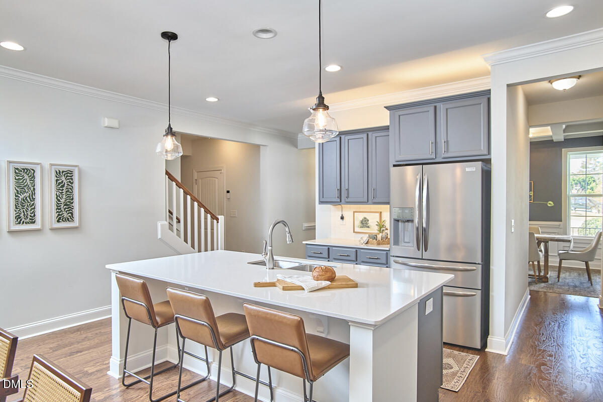 8600 Rowan Oak Court Wake Forest, NC 27587 - Photo 27 of 42 a kitchen with stainless steel appliances granite countertop a dining table chairs refrigerator and microwave