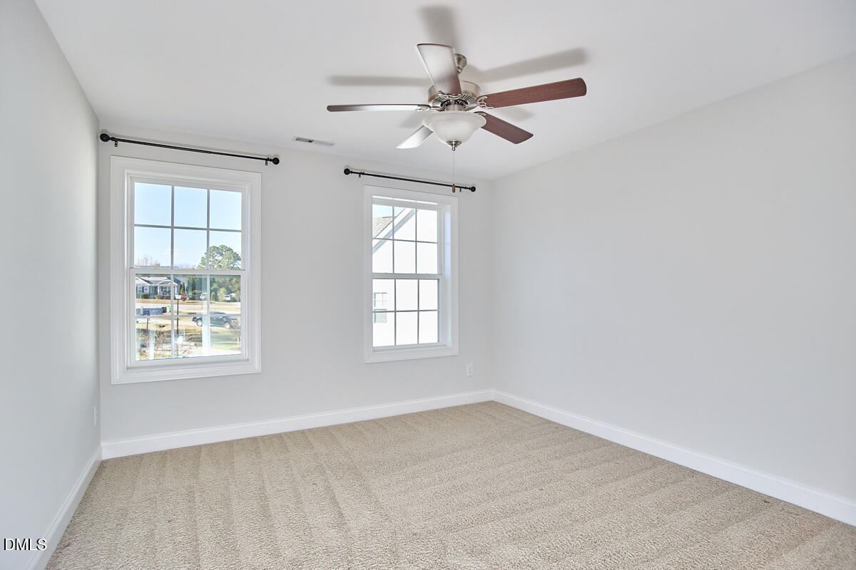 8600 Rowan Oak Court Wake Forest, NC 27587 - Photo 33 of 42 an empty room with windows and fan