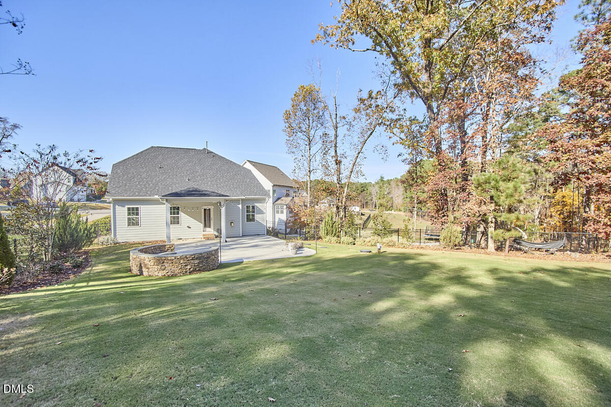 8600 Rowan Oak Court Wake Forest, NC 27587 - Photo 39 of 42 a front view of a house with a garden and trees