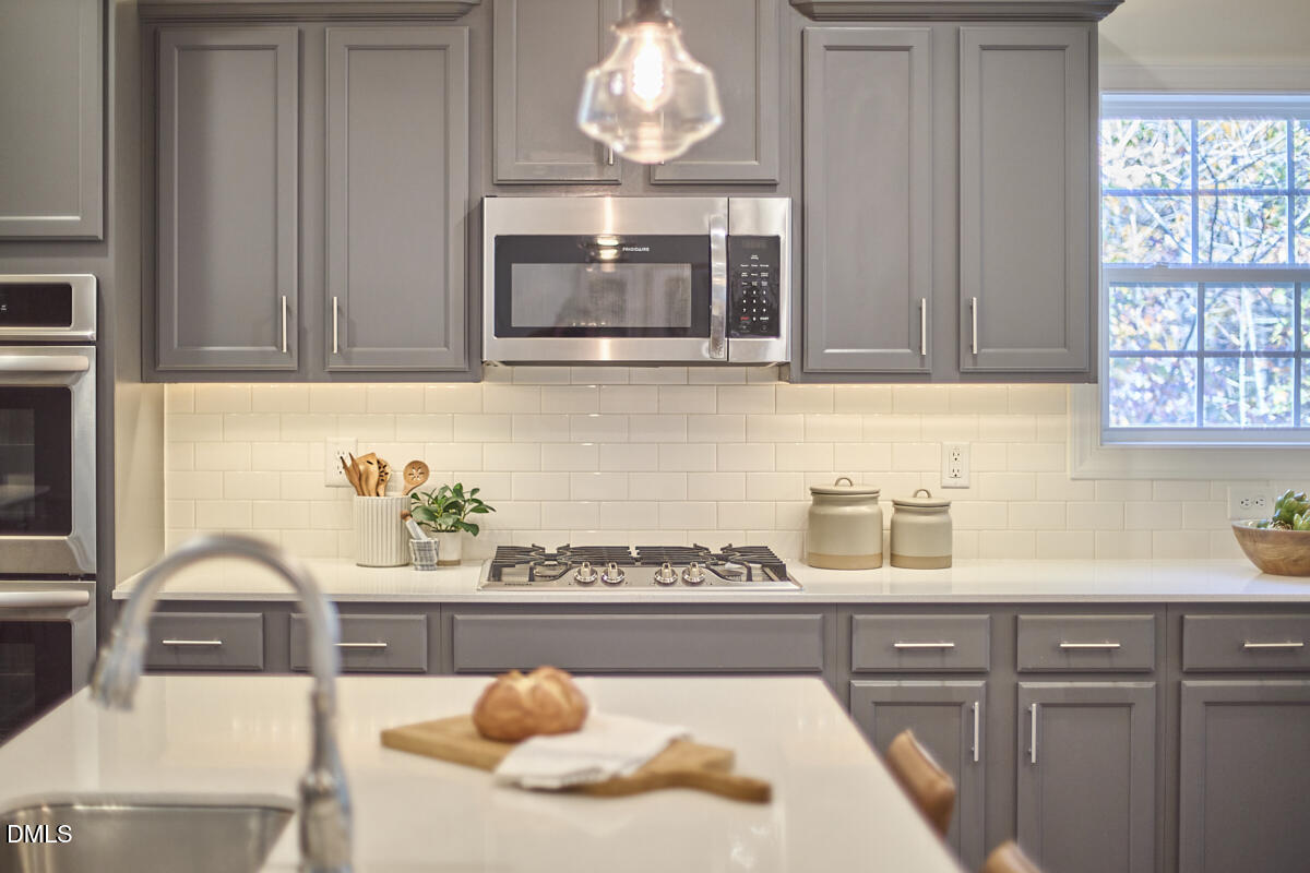 8600 Rowan Oak Court Wake Forest, NC 27587 - Photo 10 of 42 a kitchen with a sink cabinets and window