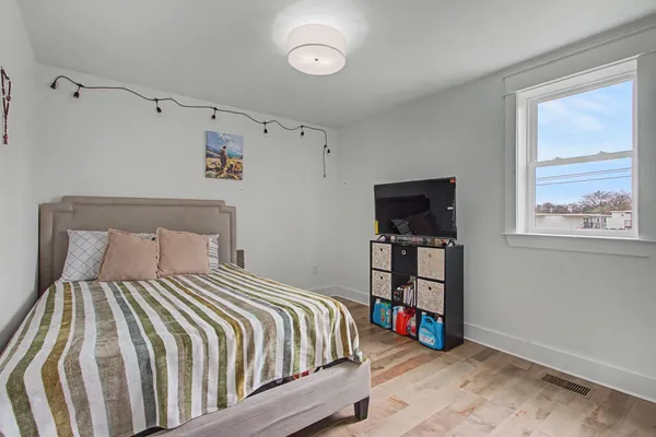 a bedroom with a bed and a window