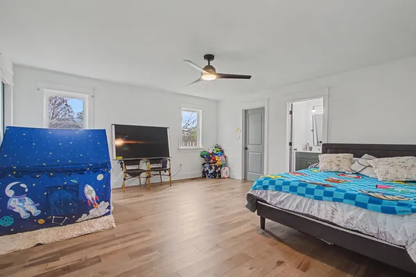 a bedroom with furniture and a flat screen tv