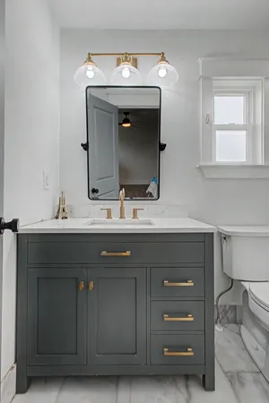 a bathroom with a sink vanity and a mirror