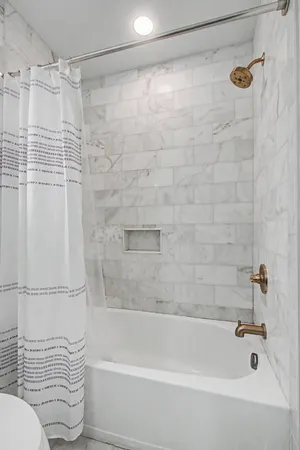 a bathroom with a shower and a toilet