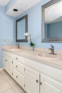 a bathroom with a sink vanity and mirror