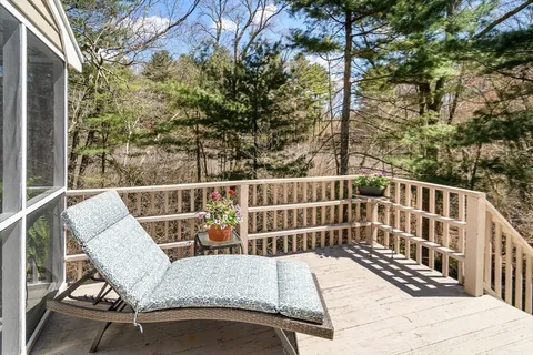 a view of a chair and table on the deck