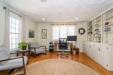 a living room with furniture a rug and a window