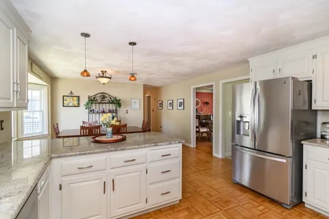 a kitchen with refrigerator and cabinets