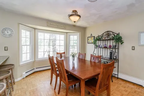 a view of a dining room with furniture window and wooden floor