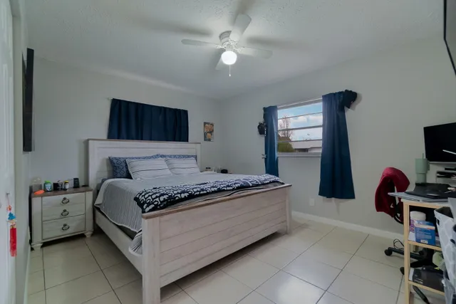 a bed room with a bed and a television