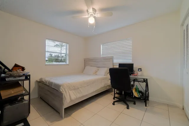 a bedroom with a bed and a chair