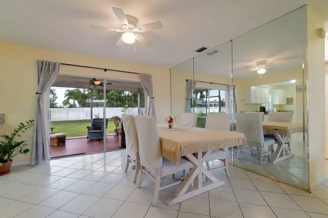 a dining room with furniture a chandelier and fireplace