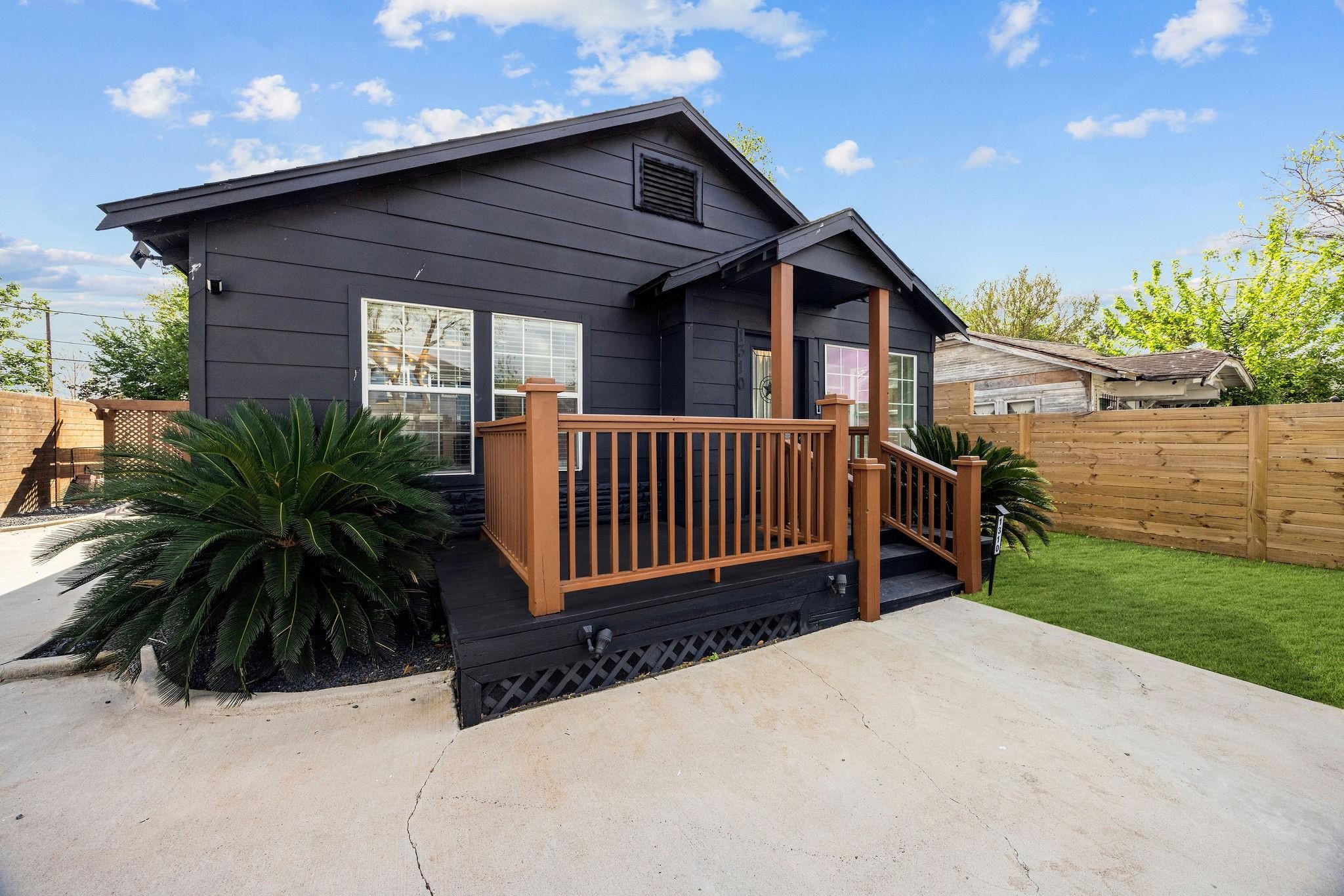 1310 Walton Street Houston, TX 77009 - Photo 2 of 19 Modern exterior with bold dark siding, warm wood accents, and a welcoming front porch.