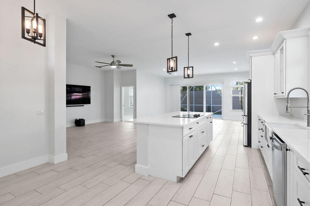 a large white kitchen with a large window