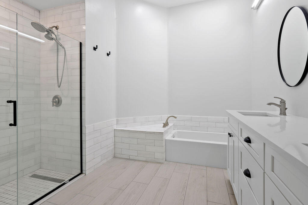 168 South Hampton Drive Jupiter, FL 33458 - Photo 19 of 33 a bathroom with a tub sink vanity and a mirror