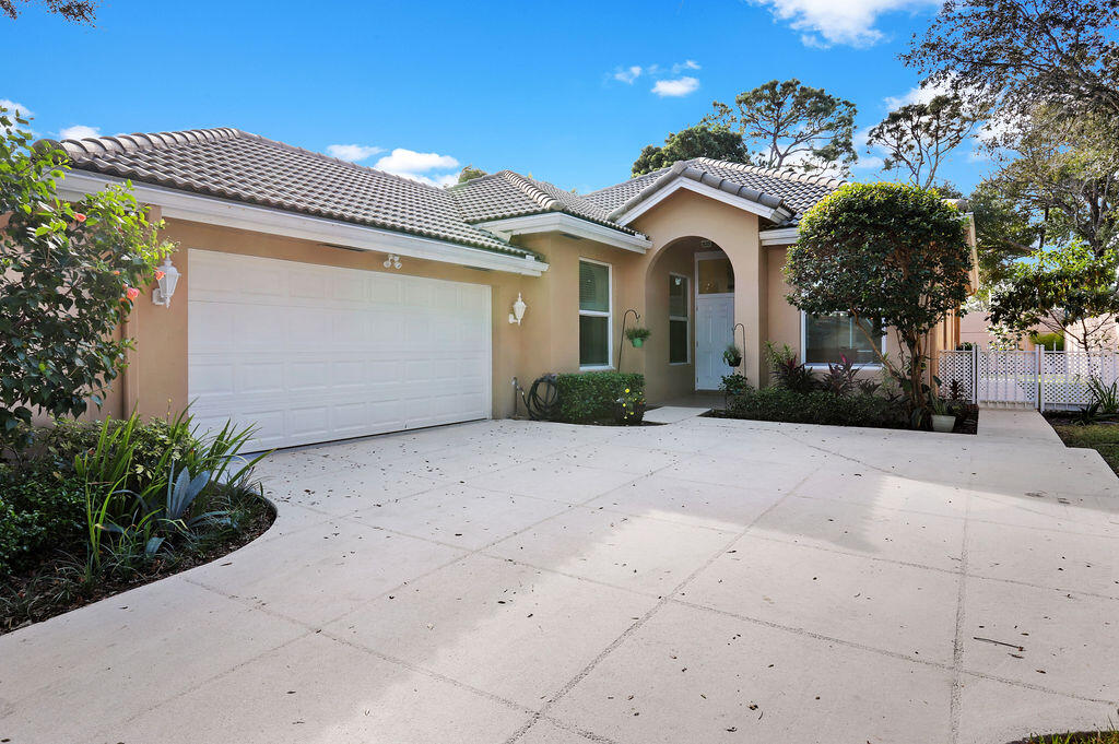 168 South Hampton Drive Jupiter, FL 33458 - Photo 2 of 33 a front view of a house with garden