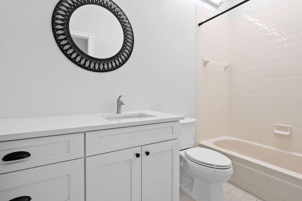 168 South Hampton Drive Jupiter, FL 33458 - Photo 23 of 33 a bathroom with a sink a mirror and a toilet