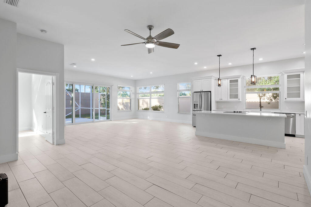 168 South Hampton Drive Jupiter, FL 33458 - Photo 7 of 33 a large white kitchen with a large window and stainless steel appliances